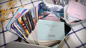 《天父樂愛你》音樂恩典卡 A 款實拍,多張圓角圖卡扇形展開放置於銀色鐵盒中,前方展示湖泊、山景與詩篇4篇8節經文卡。