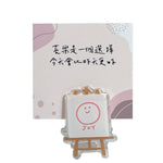 喜樂畫架留言夾商品展示，透明畫架造型搭配 JOY 笑臉圖案與「喜樂是一個選擇，今天會比昨天更好」留言卡